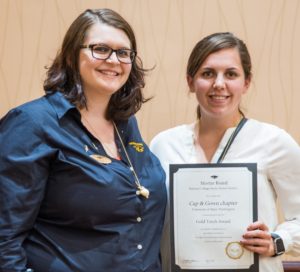 UMW chapter president Grace Henry (right) receives Mortar Board’s Most Improved Chapter and Gold Torch awards from National Council Vice President Katie Chick of Arlington, Va.