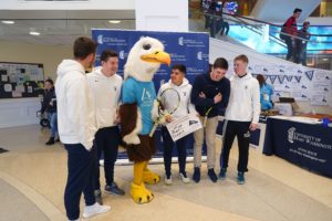 Sammy D. Eagle poses with students.