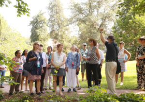 A group of grads and their guests participate in an Alumni College session on campus biodiversity, which included a tree tour of campus with Professor of Biology Alan Griffith. Photo by Karen Pearlman Photography.