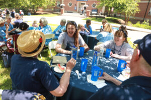 Grads and guests enjoyed brats, burgers and beverages in commemorative mugs while swapping stories about their years in Marshall and Russell hall. Photo by Karen Pearlman Photography.