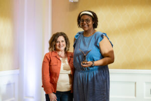 Senior Jaylyn Long shares a moment of pride with Grace Mann's mother after receiving the prestigious Grace Mann Launch Award. Long also claimed the Cedric Rucker Eagle Beyond Compare Award and the Outstanding New Program Award for her innovative creation, ASPIRE Week. Photo by Sam Cahill