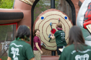 An inflatable axe-throwing competition was among the games and rides at the University of Mary Washington's Devil-Goat Day. Photo by Parker Michels-Boyce.