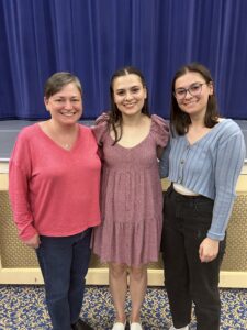 Brunt (center) with her mother, Amy Acker '94, and sister Meredith after the Performing Arts Company's big show this spring. The twins were diagnosed with hearing loss in the first grade, which inspired Brunt's decision to study genetics at Mary Washington. Photo courtesy of Madeline Brunt.