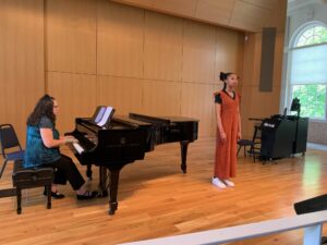 UMW student Giannii Marshall sings 'At Last' in alto, accompanied by pianist Cathy Hoskins, during Research and Creativity Day.