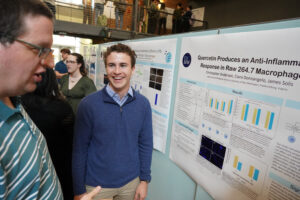 UMW student James Solis discusses his project, 'Quercetin Produces Anti-inflammatory Response in Raw 264.7 Macrophages,' with Professor of Chemistry Davis Oldham. Completed under the mentorship of Assistant Professor of Biology Laura Sipe, the project studies chronic inflammation's role in the development and proliferation of several metabolic and neurodegenerative disorders, including several types of cancers. Photo by Suzanne Carr Rossi.