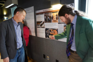 UMW sophomore Donald Glander discusses his project, 'The Electric Piano-Guitar' with Music Department Professor and Chair Brooks Kuykendall. The project, done under the mentorship of faculty mentor, Music Department Adjunct Instructor Rebecca Callaway, merges a piano and a guitar into an electro-musical instrument. Photo by Suzanne Carr Rossi.