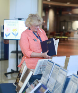 Joan Darby '74 browses books during the alumni author meet-and-greet at 2024's Reunion Weekend. Photo by Karen Pearlman.