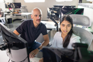 Senior Anshu Adhikari at her Synctivate internship, where she serves as a developer, reviewing something with a mentor.