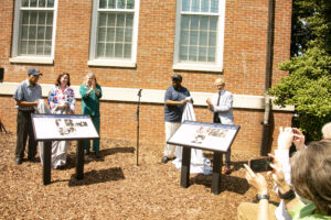The first two Fredericksburg Civil Rights Trail markers to be unveiled at UMW were "The Big Five" and "Campus Desegregation," both located at Combs Hall. Pictured from left to right are: Frank White, Fredericksburg Mayor Kerry Devine, City of Fredericksburg Tourism Stadium and Sales Manager Victoria Matthews, UMW James Farmer Multicultural Center Assistant Director Chris Williams and UMW President Troy Paino. Photo by Karen Pearlman.