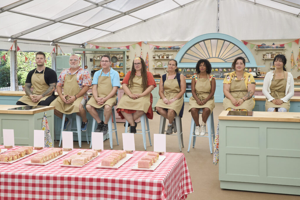 Mary Washington alumna Jenn Reyes '99 (fourth from right) poses with fellow contestants on the set 'The Great American Baking Show,' filmed under the signature pavilion-style tent at Pinewood Studios in London. Reyes' kept her eyes on the prize during the six-episode competition, including being watchful for bugs, one of the baking hazards of filming inside a tent.