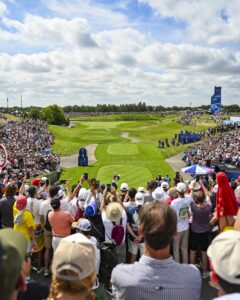 Golf gold medalist Scottie Scheffler of Team USA plays a shot from the first hole tee as fans look on during the final round of the Olympic men’s golf competition on day nine of the Olympic Games Paris 2024 at Le Golf National on August 4, 2024 in Saint-Quentin-en-Yvelines, France. Photo by Keyur Khamar/PGA TOUR via Getty Images.