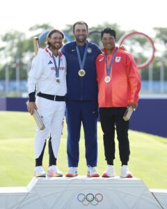 Scottie Scheffler of Team United States won the gold medal in golf during the Summer Olympics in Paris. Also pictured are silver medalist Tommy Fleetwood of Team Great Britain and bronze medalist Hideki Matsuyama of Team Japan. As senior director of communications for PGA TOUR and chair of the newly formed Olympic Golf Communications and Content Committee, UMW grad Tad Dickman is working to highlight the game of golf, especially in the Olympics. Photo by Andrew Redington/Getty Images.