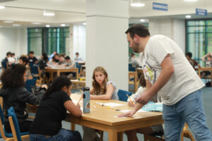 Seen here at an orientation session ahead of the first day of classes at the Academy of Technology and Innnovation at UMW, Tyler Limbrick teaches a world geography course that rolls the subjects of English and world history into a single curriculum. Photo by Karen Pearlman.