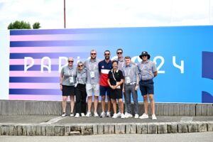 Tad Dickman '12 (third from right) and his Olympic Golf Communications and Content Committee teammates and champion swimmer and 23-time Olympic gold medalist Michael Phelps.