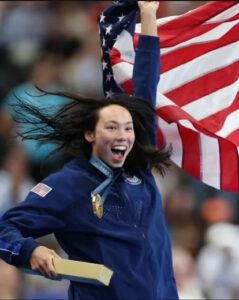 Swimmer Torri Huske smiles after winning gold in Paris at the 2024 Summer Olympics. Huske, whose coach is Mary Washington alumnus Evan Stiles '91, took three gold medals and two silvers home from Paris.