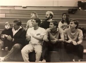 Evan Stiles '91 (front center, white shirt), longtime coach of Olympic gold medalist Torri Huske, catches a Mary Washington swim meet along with a group of alumni.