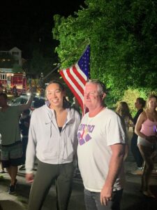 Swimmer Torri Huske poses with her coach, Mary Washington alumnus Evan Stiles '91 at a homecoming party following the Tokyo Olympics, where Huske won a silver medal in 2021.