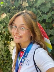 Recent UMW graduate Hadley Mantia '24 shows off the uniform she wears to greet spectators flying to Paris from all over the world. Mantia works in hospitality for major Olympics sponsor Allianz.