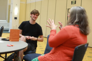 UMW junior Jorrin Casa de Calvo (left), who earned a spot on the 2024 ALL IN Student Voting Honor Roll for his efforts to increase voter participation at Mary Washington speaks to Professor of Political Science and International Affairs Rosalyn Cooperman at last week's Virginia Student Voting Summit. Photo by Kearen Pearlman.