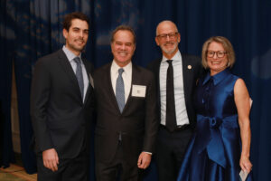 From left to right: Remy Pohl ’16 and Ron Pohl pose with UMW President Troy Paino and his wife, Kelly, at the Celebration of Giving in December 2023. Remy Pohl is a friend and attorney to the late Irene Piscopo Rodgers '59, who bequeathed a $30 million gift to Mary Washington, the largest in University history. Photo by Karen Pearlman.