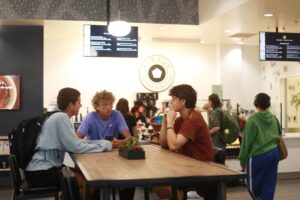 Students gather during the ribbon-cutting event for UMW's new coffee shop, For Five Roasters. Photo by Karen Pearlman.