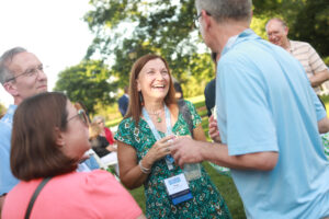 Renee Kuntz '85 (center, chatting with friends at Reunion Weekend in 2022) recently made a pledge that helped UMW's Beyond the Classroom Endowment pass the $1 million mark to help Mary Washington students engage in high-impact learning experiences like study abroad, internships and undergraduate research. Photo by Karen Pearlman.