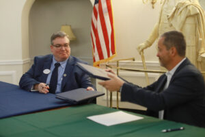 UMW Provost Timothy O'Donnell (left) and George Mason University Provost James Antony complete the official signing at a ceremony that reconfirmed a partnership between the two schools for an accelerated degree pathway program in computer science, engineering and law. Photo by Karen Pearlman.