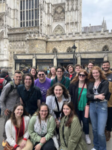 Nathaniel Huff '24 (center, green shirt and glasses) and his classmates visit Westminster Abbey during the UMW Theatre in London trip in summer 2023. Nathaniel was able to take the trip because he received the Beyond the Classroom Education Abroad Scholarship, which was awarded for the first time last year. Photo courtesy of UMW Theatre.