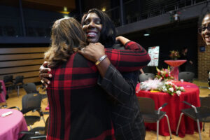 Susan Coleman, who won the 2023 Metzger Award, passes the torch to this year’s winner, Michelle Caldwell Thompson, with a big hug. Photo by Suzanne Carr Rossi.