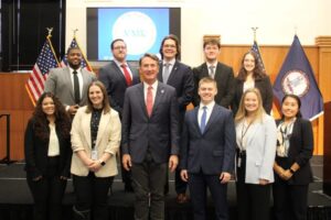 UMW alumna Kristen Ramey '17 (front row, second from left) poses for a photo with Gov. Glenn Youngkin and other Virginia Management Fellows. As a member of VMF's sixth cohort, Ramey is putting the business and public policy background she gained from Mary Washington to work as she explores careers in state public service. Photo courtesy of Kristen Ramey.