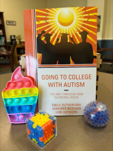 The Impact Grant for ‘Soft Landings’ covered the cost of a textbook, ‘Going to College with Autism,’ seen here with a collection of fidget toys to help students when they feel overstimulated. The book is filled with success stories of students with autism spectrum disorder. Photo courtesy of CJ Porter.