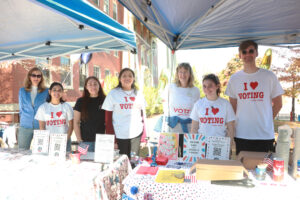 Students and staff set up near the Bell Tower with coffee, doughnuts, patriotic balloons, T-shirts, buttons, stickers, sample ballots, and voter information. Photo by Karen Pearlman.