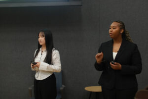 UMW business students Mia Fischl and Alanah Cleare answer questions from the judges during the fall 2024 College of Business Case Competition. Photo by Karen Pearlman.