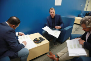 From left to right: Craig Schneibolk, Andrew Blate '04 and Travis Bjorklund ’02 deliberate following the Case Competition presentations. The three judges chose first- second- and third-place winners based on a number of criteria. Photo by Karen Pearlman.