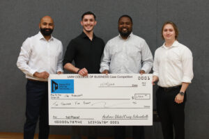 From left to right: Sudhanshu Sarin, Travis Bjorklund, Andrew Blate, Craig Schneibolk, Jeremy Sanchez, Dwayne Clarke and Cole Hudak pose during UMW's fall 2024 College of Business Case Competition. Blate, who graduated from UMW in 2004, and Schneibolk led the way in establishing the endowed fund for the competition's annual award money and served as judges, along with Bjorklund. Sarin, Sanchez, Clarke and Hudak, all UMW business students, teamed up for a first-place finish. Photo by Karen Pearlman.