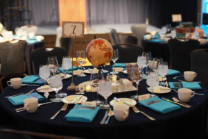 With a study abroad theme, tables were decorated with globes, suitcases and postcards from far-flung locales across the globe. Photo by Karen Pearlman.