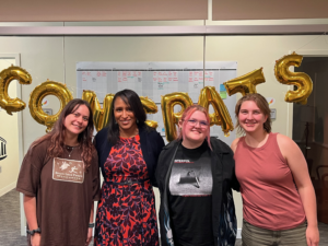 UMW students who created the coloring book with mentor Antoinette Jenkins, director of Rappahannock Work and Learn Collaborative. Left to right: Kyra Donlon, Jenkins, MacKenzie Martin, and Lexi St. John.