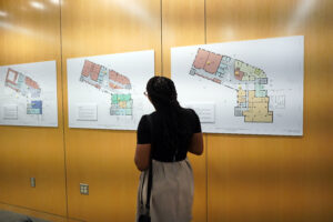 Center for Prevention and Education Director Marissa Miller checks out 'The HCC That Wasn't' installation. The installation, which illustrates how building plans for the Hurley Convergence Center morphed over time, is part of an exhibit celebrating the 10th anniversary of the HCC. Photo by Suzanne Carr Rossi.