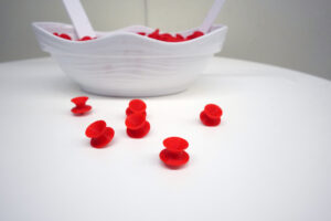 A pair of red 'spin' chairs outside the Hurley Convergence Center's fourth-floor Digital Knowledge Center is a nearly irresistible attraction. Tiny 3D-printed replicas for the taking are part of the 'A Decade of Digital Convergence' exhibit, on view in the HCC's Digital Gallery through the end of the fall semester. Photo by Suzanne Carr Rossi.