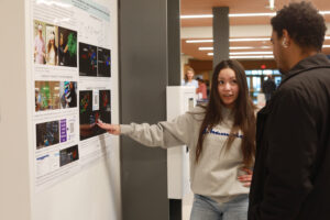 Caitlin Harris presents her research project - 'Enhancing Biomolecular visual literacy through Virtual Reality: Understanding Protein Structures with Nanome' - during the Jepson Science Center Fall Research Symposium. Photo by Karen Pearlman.