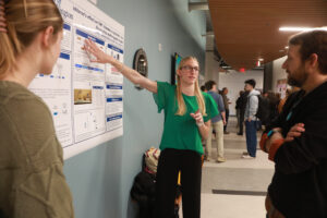 Carleigh Wood (left) and Delaney Humphrey, both biology majors on a pre-med track, present their research on myotonic dystrophy using fruit flies during the Jepson Science Center Fall Research Symposium. Photo by Karen Pearlman.