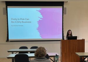 UMW senior Brianna Kenealy, a business administration major, presents her research on 'pink tax' - the tendency for products marketed toward women to be priced higher than products marketed toward men - during the Honors Senior Capstone Fall Symposium.