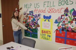 Emily Thomas '27 (pictured) and many other UMW students put in hours of work to coordinate the event, from recruiting and organizing donations to wrapping boxes.