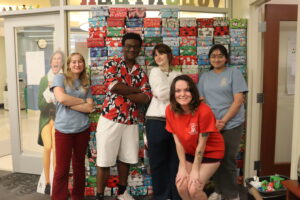 Mary Wash students pose with over 300 gift boxes that were filled with donations from the campus community.