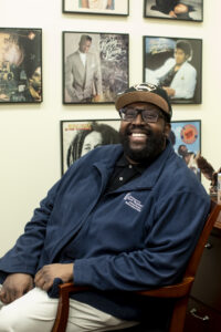 James Farmer Multicultural Center Assistant Director Chris Williams' office is decked out with covers of albums, many by artists he's written about. A longtime music journalist, Williams was inducted into the Recording Academy - giving him a voice in this year's Grammy Awards - this past summer. Photo by Karen Pearlman.