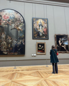 Hayley takes a moment to ponder paintings at the Louvre in Paris. Photo courtesy of Hayley Madden.