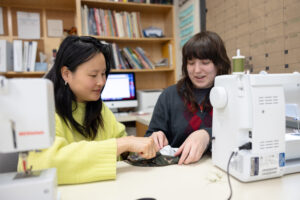 Alicia Austin works with UMW junior Claire Schultz, a theatre major also interested in costume design. Photo by Parker Michels-Boyce.