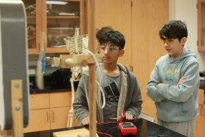 A team of students set up their device in the “Wind Power” event which measured voltage and tested principles of alternative energy. Photo by Karen Pearlman.