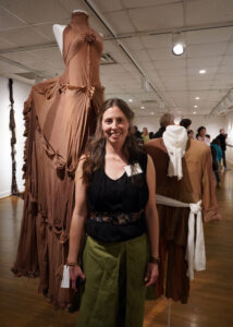 Mary Washington alumna Sarah Perry ’07 poses with her elaborate artwork crafted of pantyhose on wire.